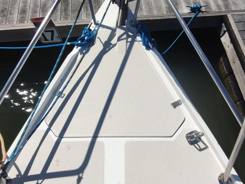 Slide: The Image of Bow of a 1990 Catalina C-34 sailboat docked, with blue ropes and metal railings. - 8