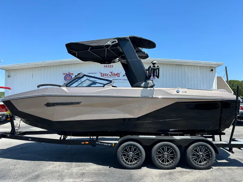 Slide: The Image of 2025 Nautique Super Air Nautique G23 boat on trailer, side view, sunny day. - 1