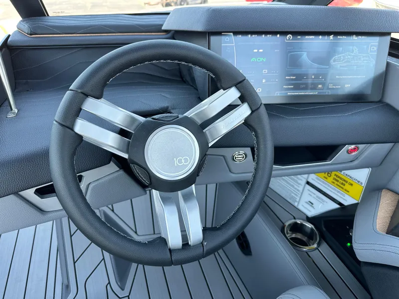 Slide: The Image of 2025 Nautique Super Air Nautique G23 steering wheel and dashboard display. - 11