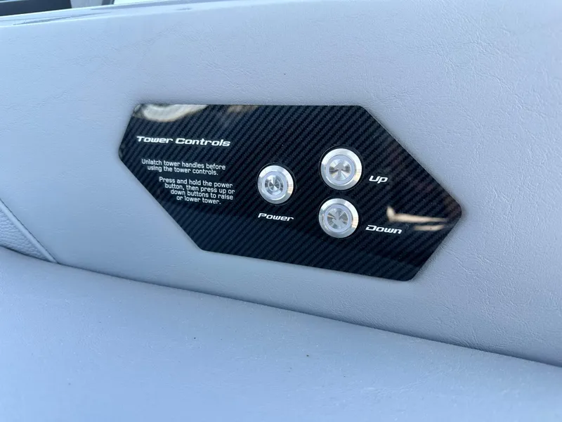 Slide: The Image of Tower controls panel on 2025 Nautique Super Air Nautique G23 boat interior. - 13