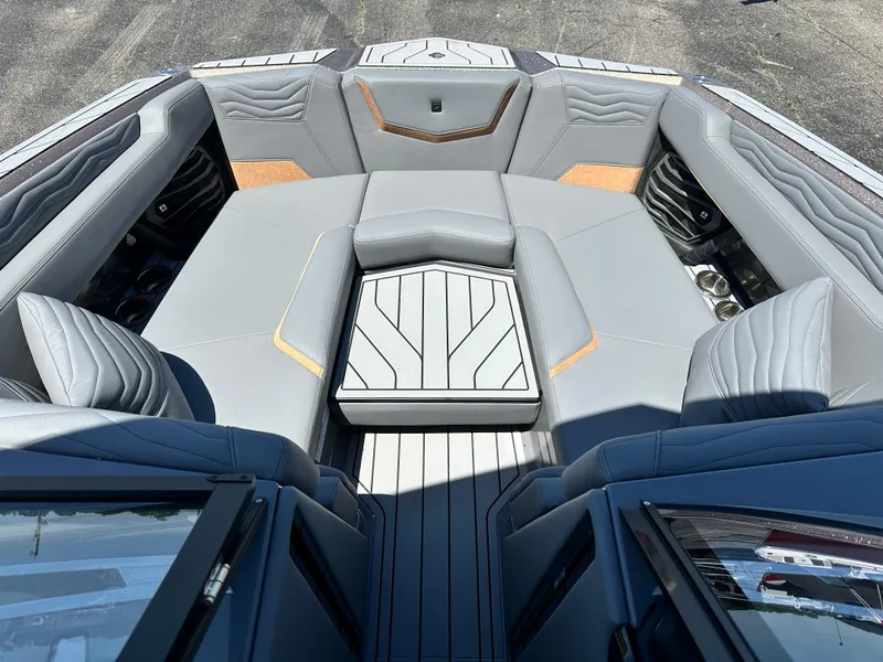 Slide: The Image of 2025 Nautique Super Air Nautique G23 boat interior with luxurious gray seating and modern design. - 14