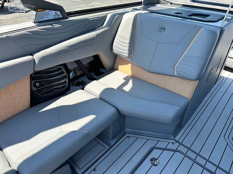 Slide: The Image of 2025 Nautique Super Air Nautique G23 interior with gray seating and modern design. - 9