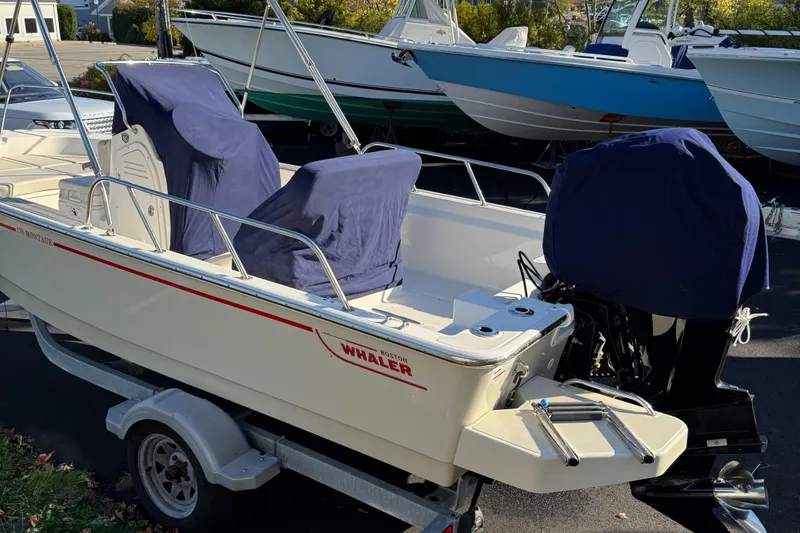 Slide: The Image of 2018 Boston Whaler 170 Montauk boat on trailer, covered seats and motor. - 10