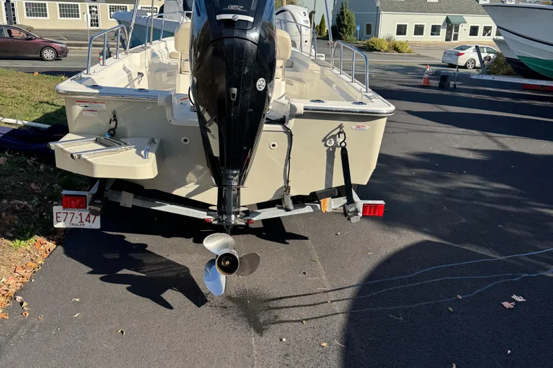 Slide: The Image of 2018 Boston Whaler 170 Montauk boat on trailer, rear view, parked outdoors. - 2