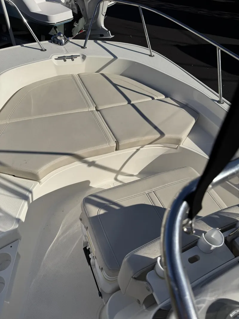 Slide: The Image of 2018 Boston Whaler 170 Montauk boat interior with cushioned seating. - 5