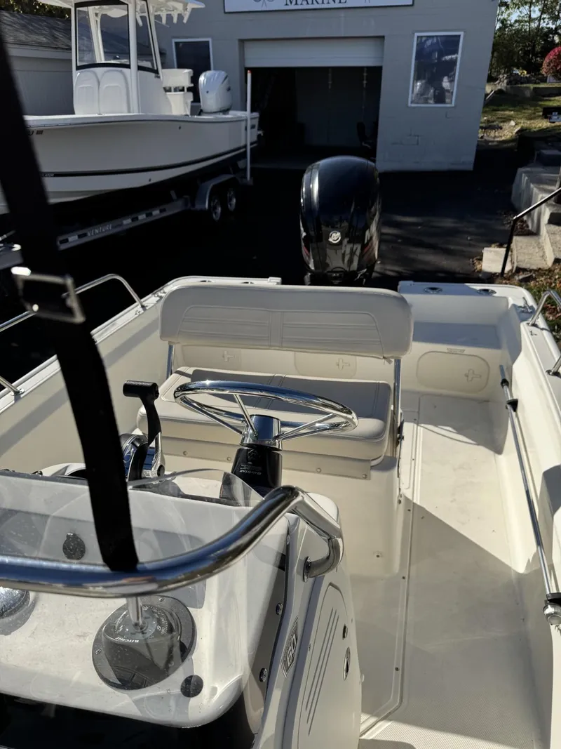 Slide: The Image of 2018 Boston Whaler 170 Montauk boat interior with steering wheel and seating. - 6