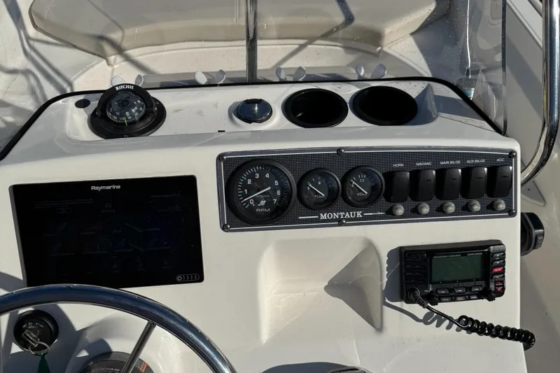 Slide: The Image of 2018 Boston Whaler 170 Montauk dashboard with gauges and navigation equipment. - 9