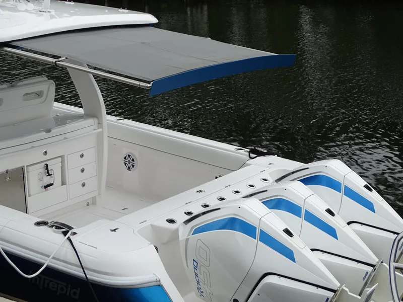 Slide: The Image of 2022 Intrepid 407 Panacea boat with triple engines and sleek design on water. - 13