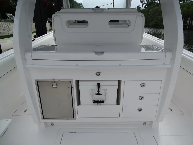 Slide: The Image of 2022 Intrepid 407 Panacea boat interior with storage compartments and cooler. - 18
