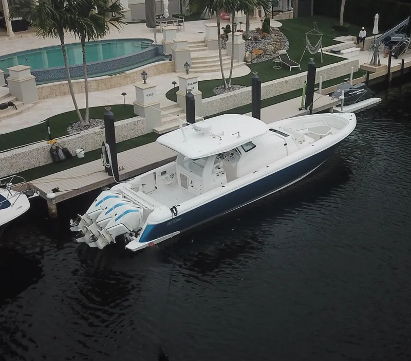 Slide: The Image of 2022 Intrepid 407 Panacea docked near luxury waterfront property. - 3