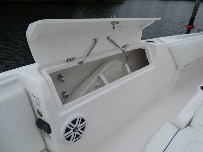 Slide: The Image of 2022 Intrepid 407 Panacea boat storage compartment with open lid and speaker. - 33
