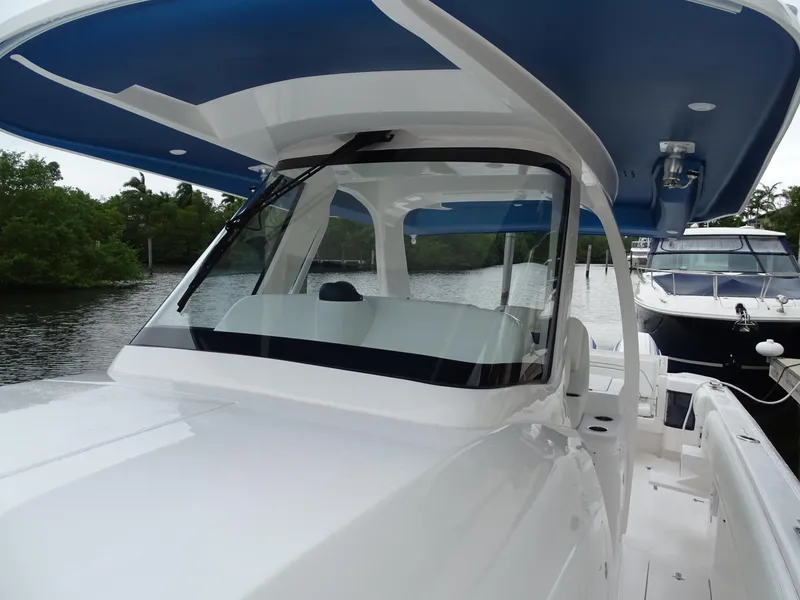 Slide: The Image of 2022 Intrepid 407 Panacea boat with sleek design on a calm waterway. - 40