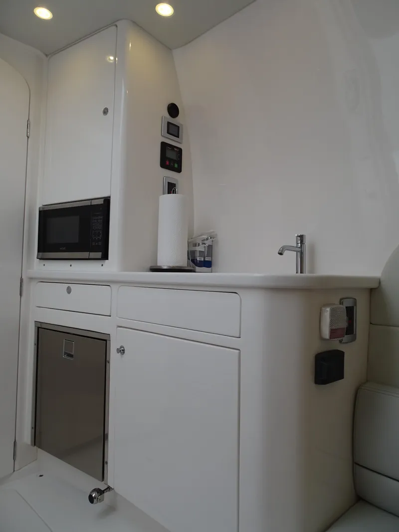 Slide: The Image of 2022 Intrepid 407 Panacea boat interior with kitchenette, microwave, and sink. - 45