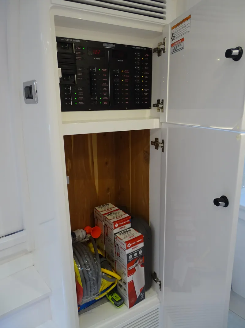 Slide: The Image of Electrical panel and storage inside 2022 Intrepid 407 Panacea boat. - 46