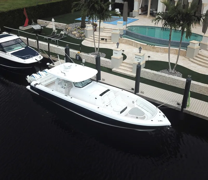 Slide: The Image of 2022 Intrepid 407 Panacea docked near luxury waterfront property. - 6