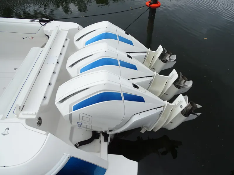 Slide: The Image of 2022 Intrepid 407 Panacea with triple outboard engines on calm water. - 9