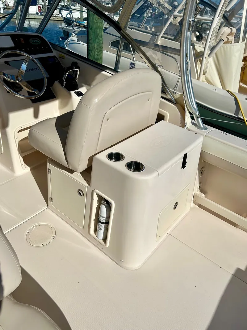Slide: The Image of 2012 Grady-White Freedom 285 boat interior with helm seat and console. - 11