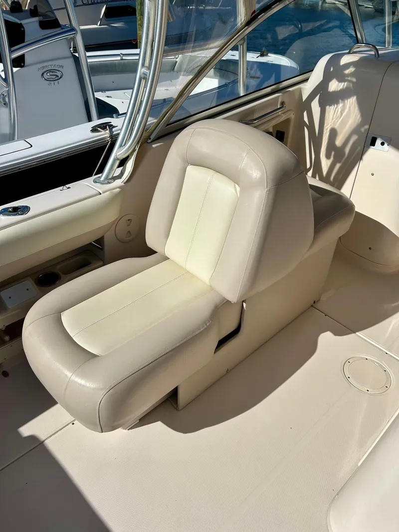 Slide: The Image of 2012 Grady-White Freedom 285 boat interior with beige seating. - 12