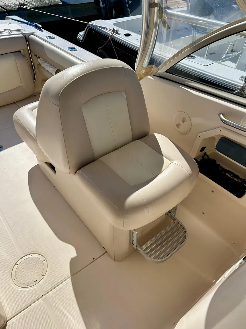 Slide: The Image of 2012 Grady-White Freedom 285 boat interior with beige seating. - 13