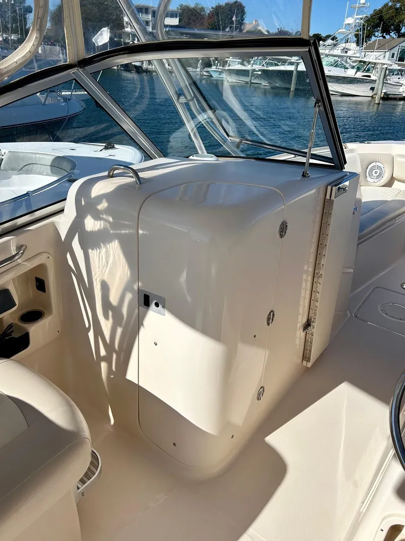 Slide: The Image of 2012 Grady-White Freedom 285 boat interior, featuring helm and seating area. - 14