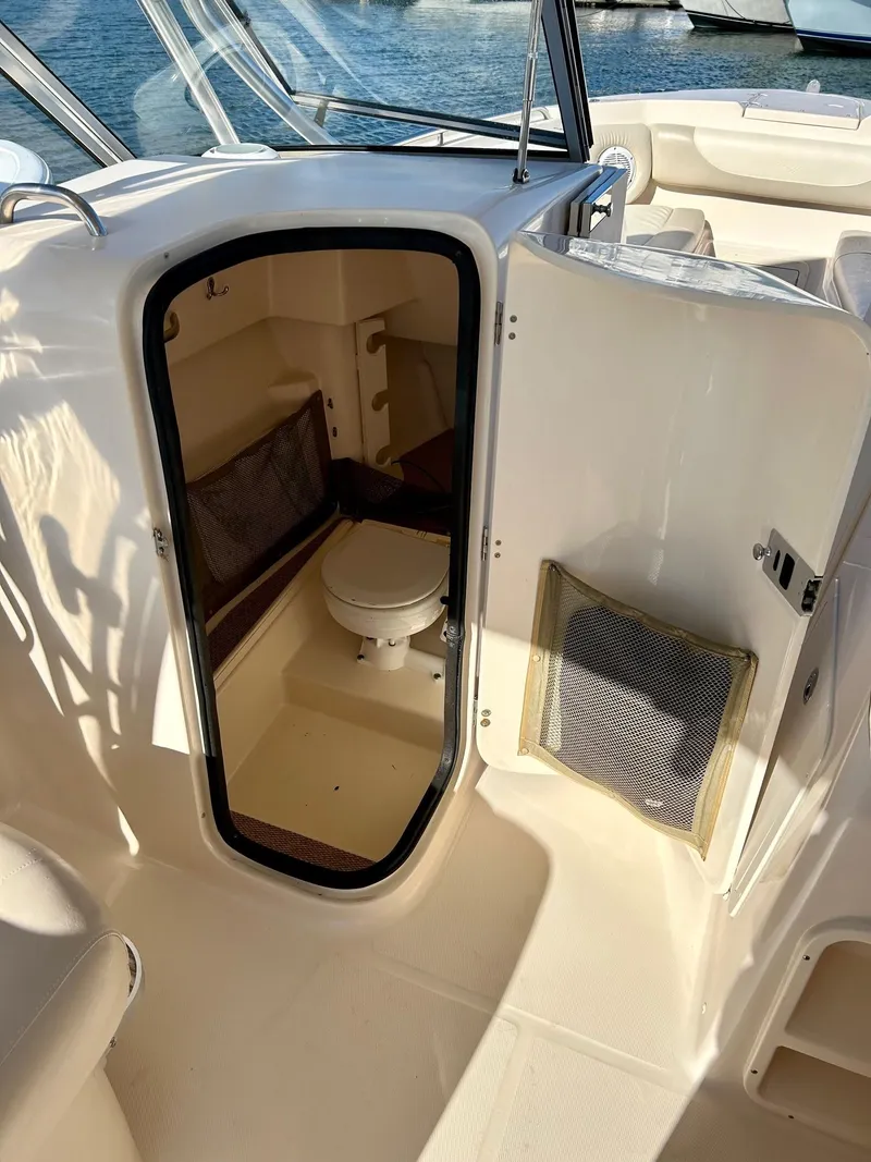 Slide: The Image of 2012 Grady-White Freedom 285 boat interior with compact marine toilet. - 15
