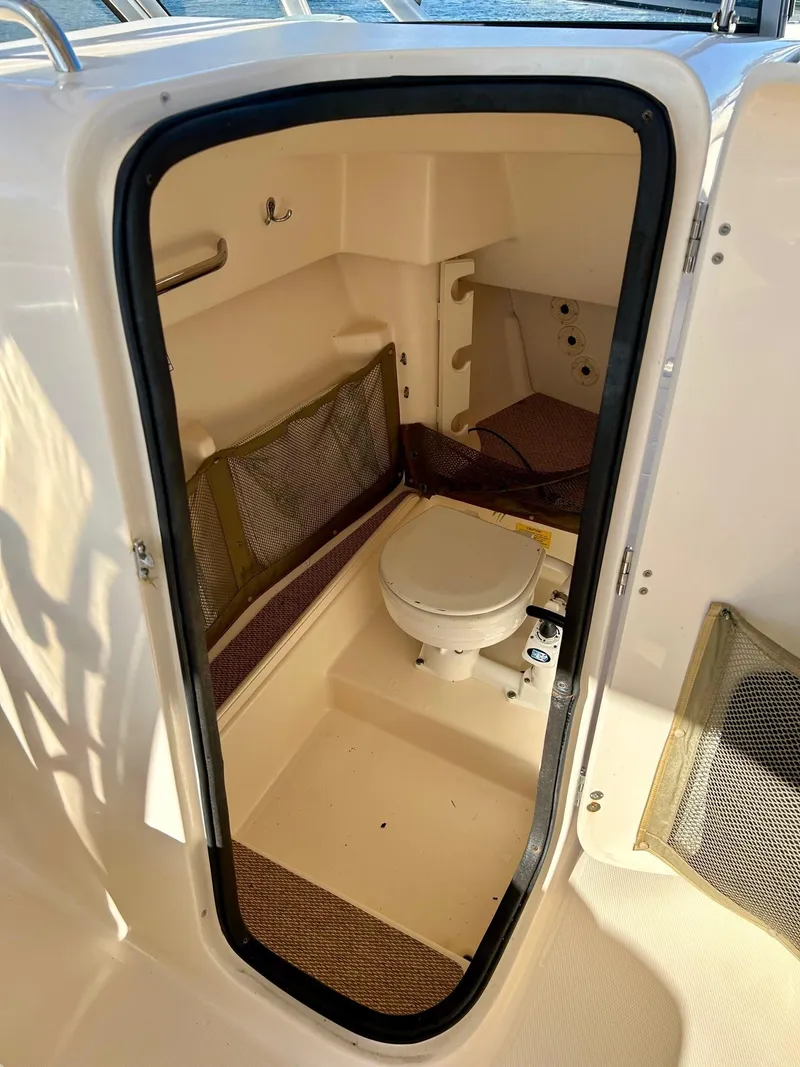 Slide: The Image of 2012 Grady-White Freedom 285 boat interior with compact marine toilet. - 16