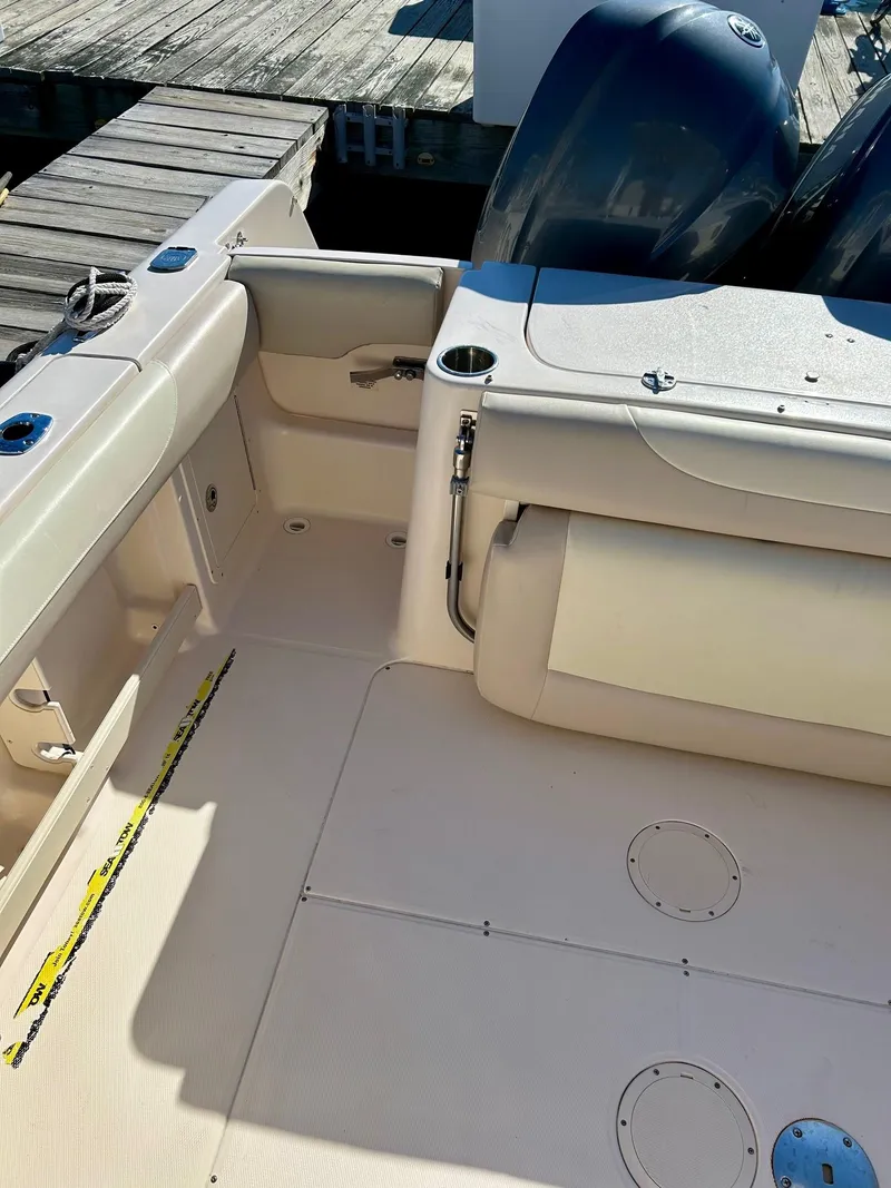 Slide: The Image of 2012 Grady-White Freedom 285 boat interior with dual engines at dock. - 18