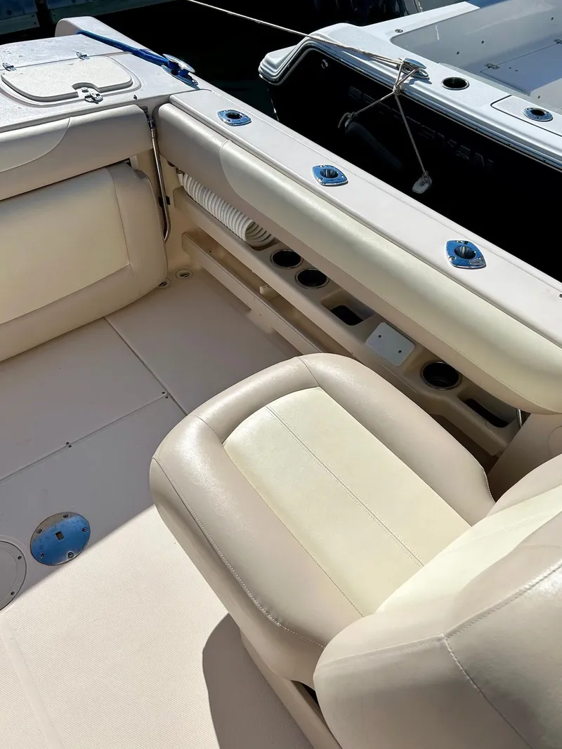 Slide: The Image of 2012 Grady-White Freedom 285 boat interior with beige seating and cup holders. - 19