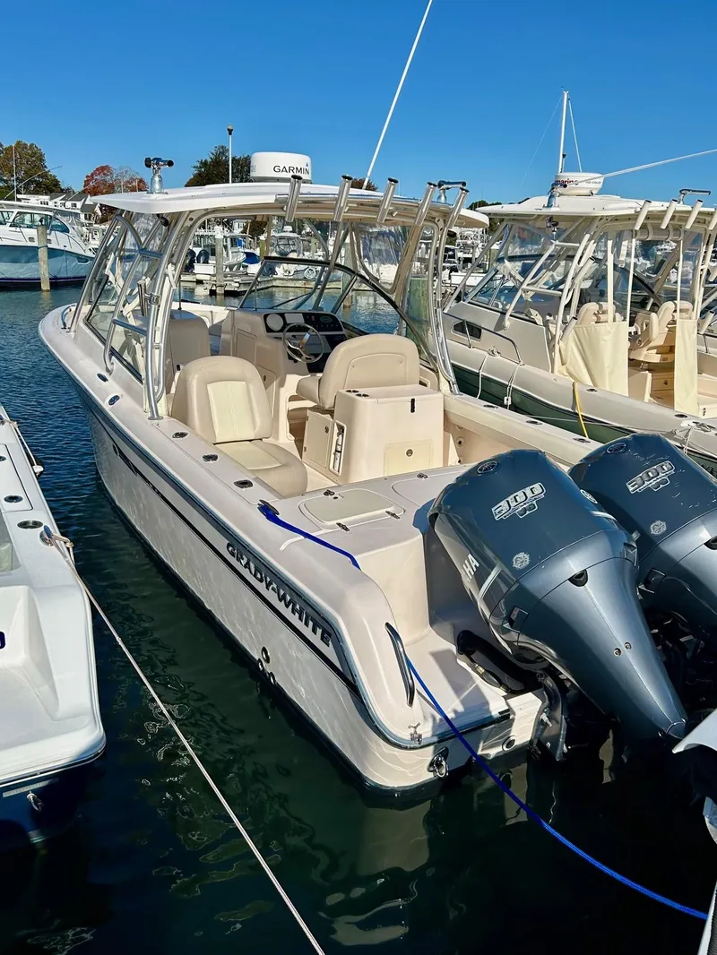 Slide: The Image of 2012 Grady-White Freedom 285 boat docked with twin engines. - 2