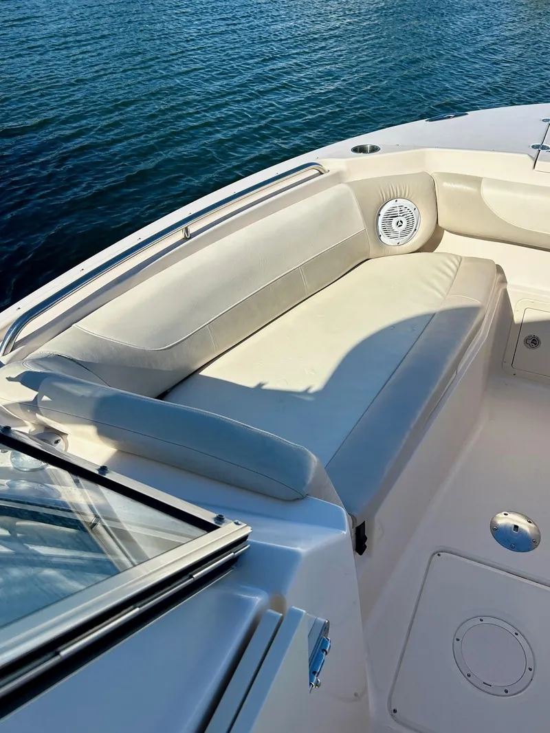 Slide: The Image of 2012 Grady-White Freedom 285 boat interior with cushioned seating by the water. - 22