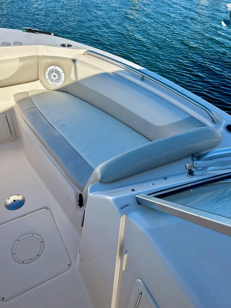Slide: The Image of 2012 Grady-White Freedom 285 boat interior with cushioned seating and water view. - 23