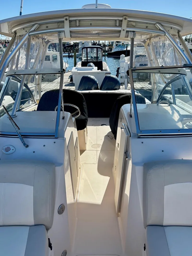 Slide: The Image of 2012 Grady-White Freedom 285 boat interior with seating and helm, docked at marina. - 24