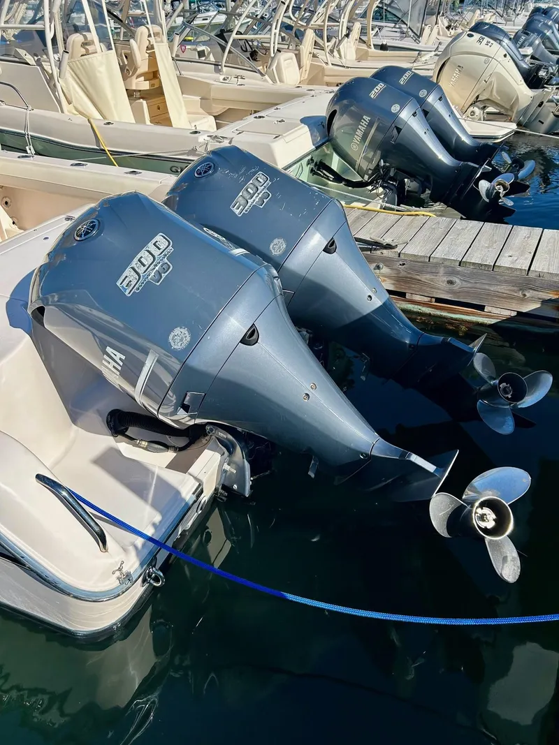 Slide: The Image of 2012 Grady-White Freedom 285 with dual outboard engines docked at marina. - 26