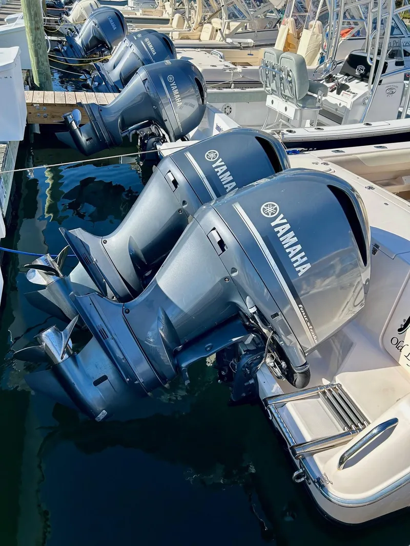 Slide: The Image of Yamaha outboard motors on a 2012 Grady-White Freedom 285 boat docked in a marina. - 27