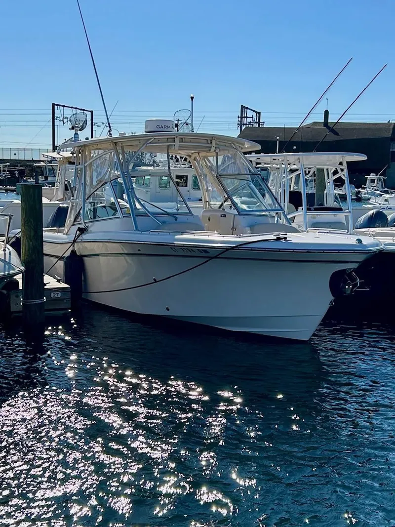 Slide: The Image of 2012 Grady-White Freedom 285 boat docked in sunny marina. - 4