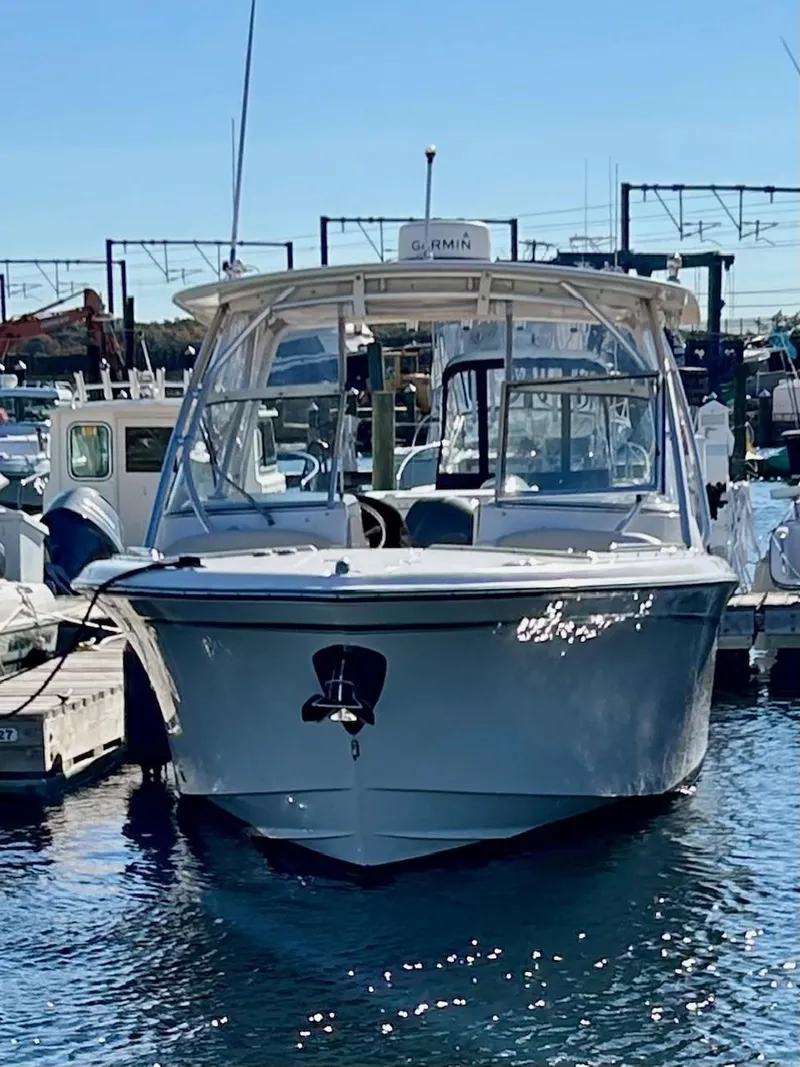 Slide: The Image of 2012 Grady-White Freedom 285 boat docked in marina. - 5