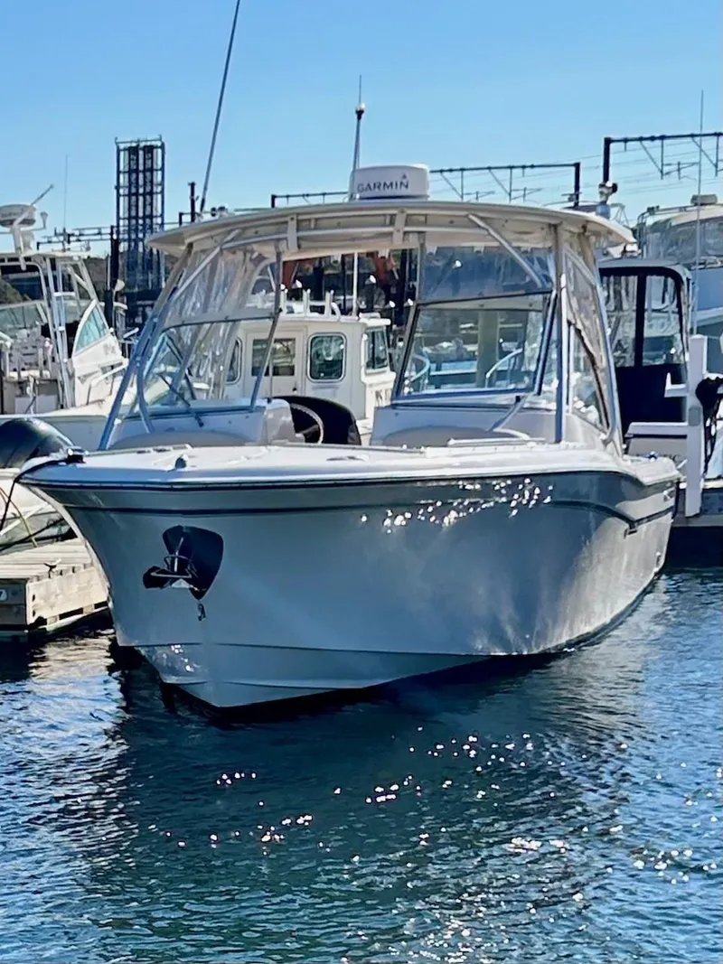 Slide: The Image of 2012 Grady-White Freedom 285 boat docked in marina under clear blue sky. - 6
