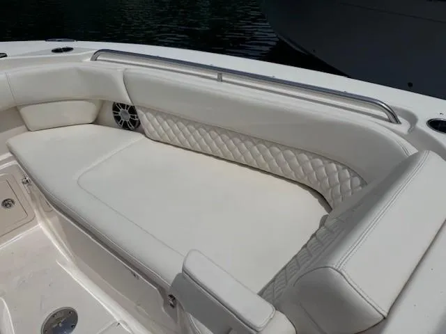 Slide: The Image of 2023 Grady-White Freedom 307 boat interior with white cushioned seating. - 12