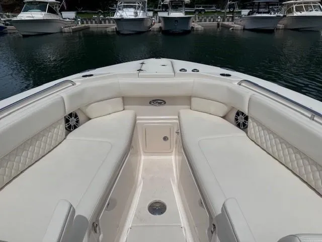 Slide: The Image of 2023 Grady-White Freedom 307 boat interior with spacious seating at marina. - 2