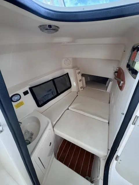 Slide: The Image of 2023 Grady-White Freedom 307 cabin interior with seating and sink. - 5