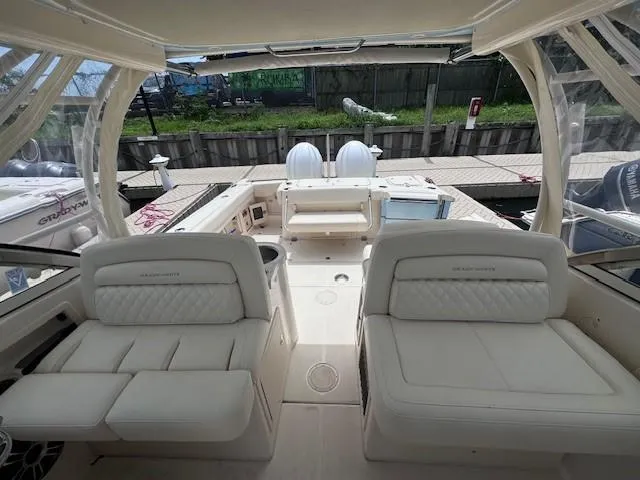 Slide: The Image of 2023 Grady-White Freedom 307 boat interior with plush seating and dual engines. - 6