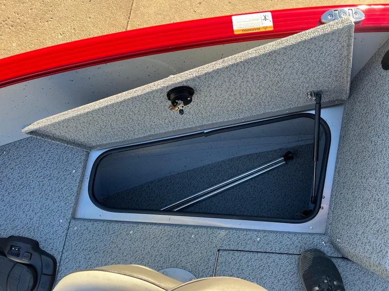 Slide: The Image of 2025 Lund 1775 Adventure Sport boat storage compartment with open lid. - 10