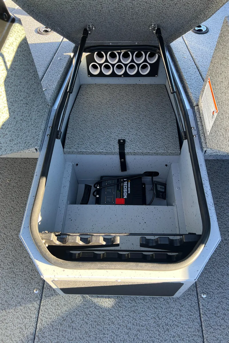 Slide: The Image of 2025 Lund 1775 Adventure Sport boat storage compartment with rod holders and battery. - 11