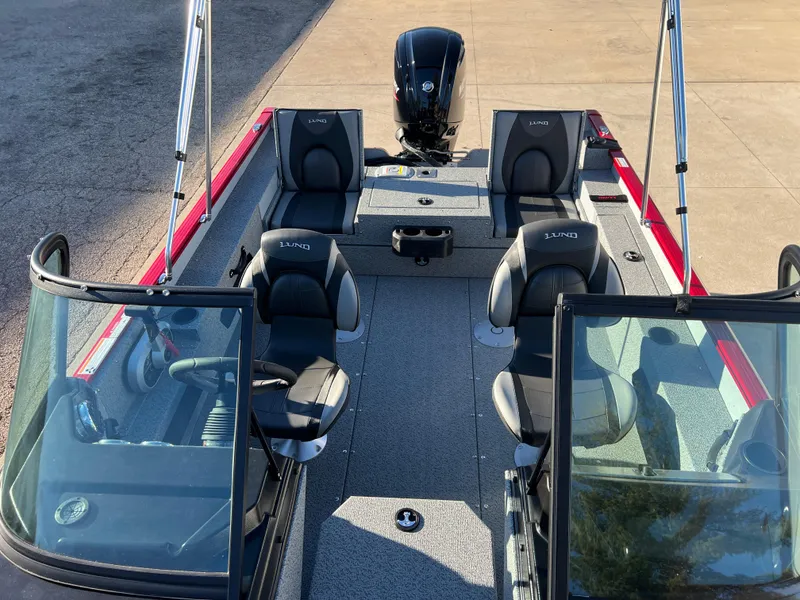 Slide: The Image of 2025 Lund 1775 Adventure Sport boat interior with seating and motor. - 12