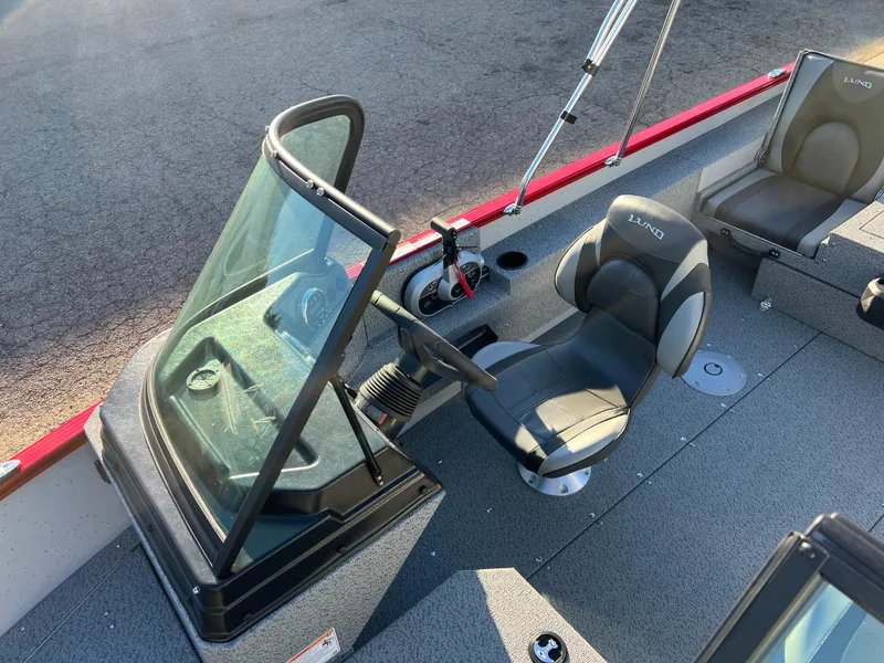 Slide: The Image of 2025 Lund 1775 Adventure Sport boat interior with steering console and seating. - 13