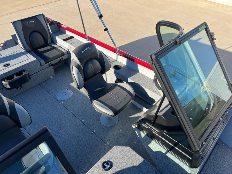 Slide: The Image of 2025 Lund 1775 Adventure Sport boat interior with sleek seating and windshield. - 14