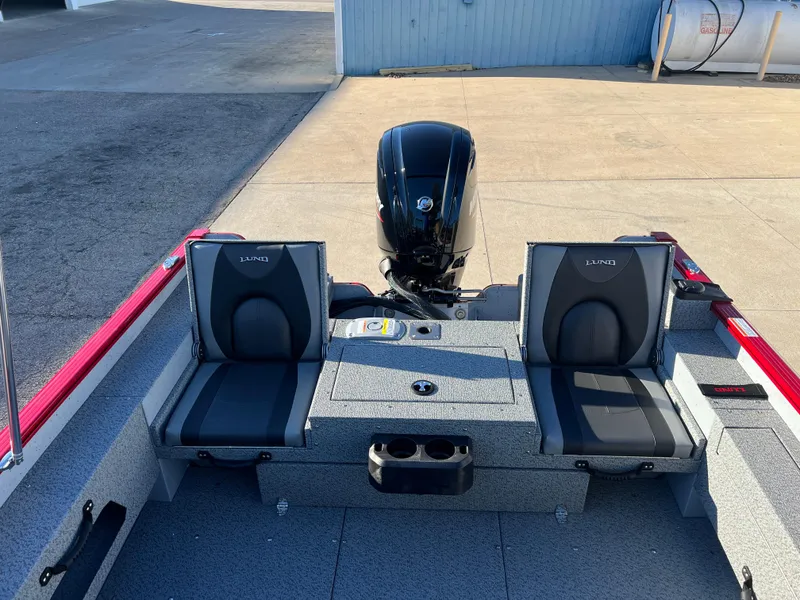 Slide: The Image of 2025 Lund 1775 Adventure Sport boat interior with dual seats and motor. - 17