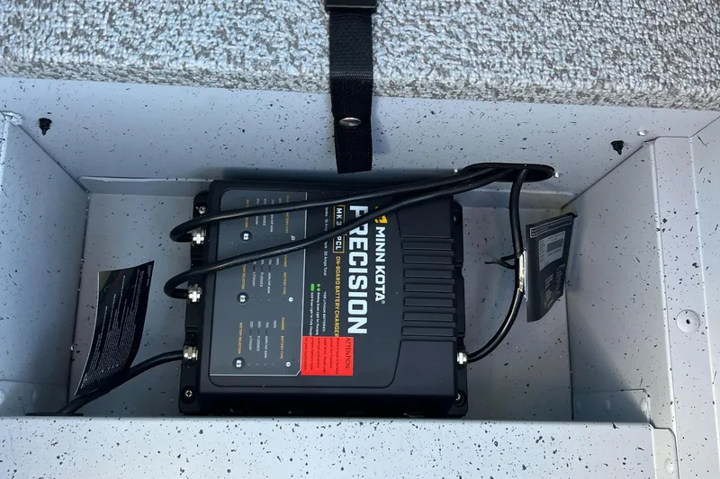 Slide: The Image of Minn Kota Precision charger in 2025 Lund 1775 Adventure Sport boat compartment. - 22