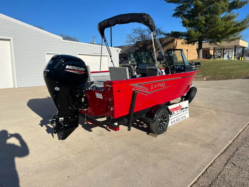 Slide: The Image of 2025 Lund 1775 Adventure Sport boat with Mercury engine, parked outdoors. - 6