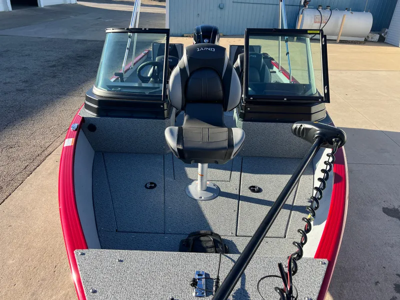 Slide: The Image of 2025 Lund 1775 Adventure Sport boat with seating and windshield, docked outdoors. - 7